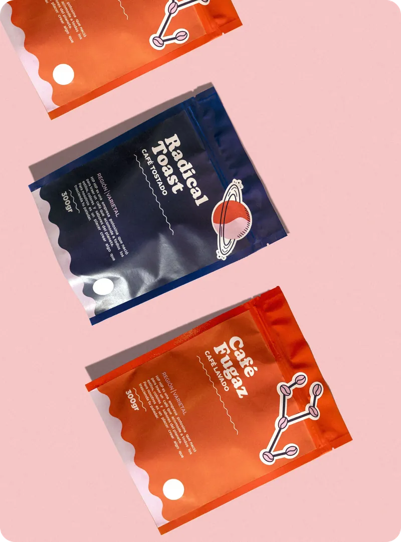 Radical Toast and Café Fugaz coffee bags laid out on a pink background