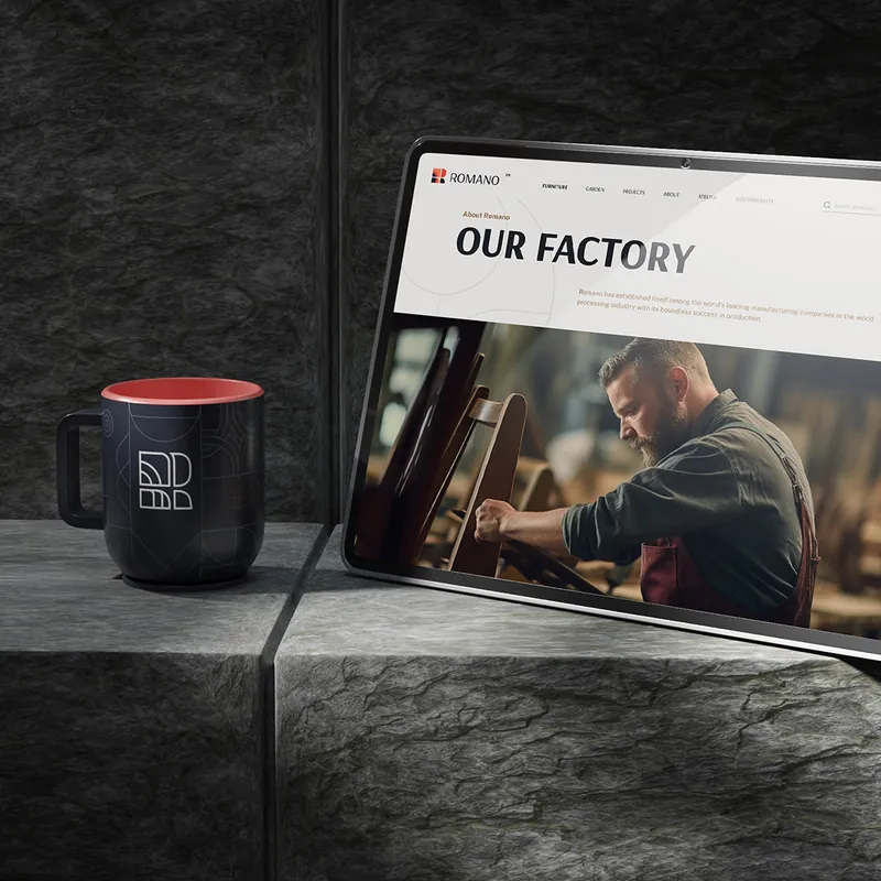 Romano website “Our factory” page on a laptop in a dark workshop